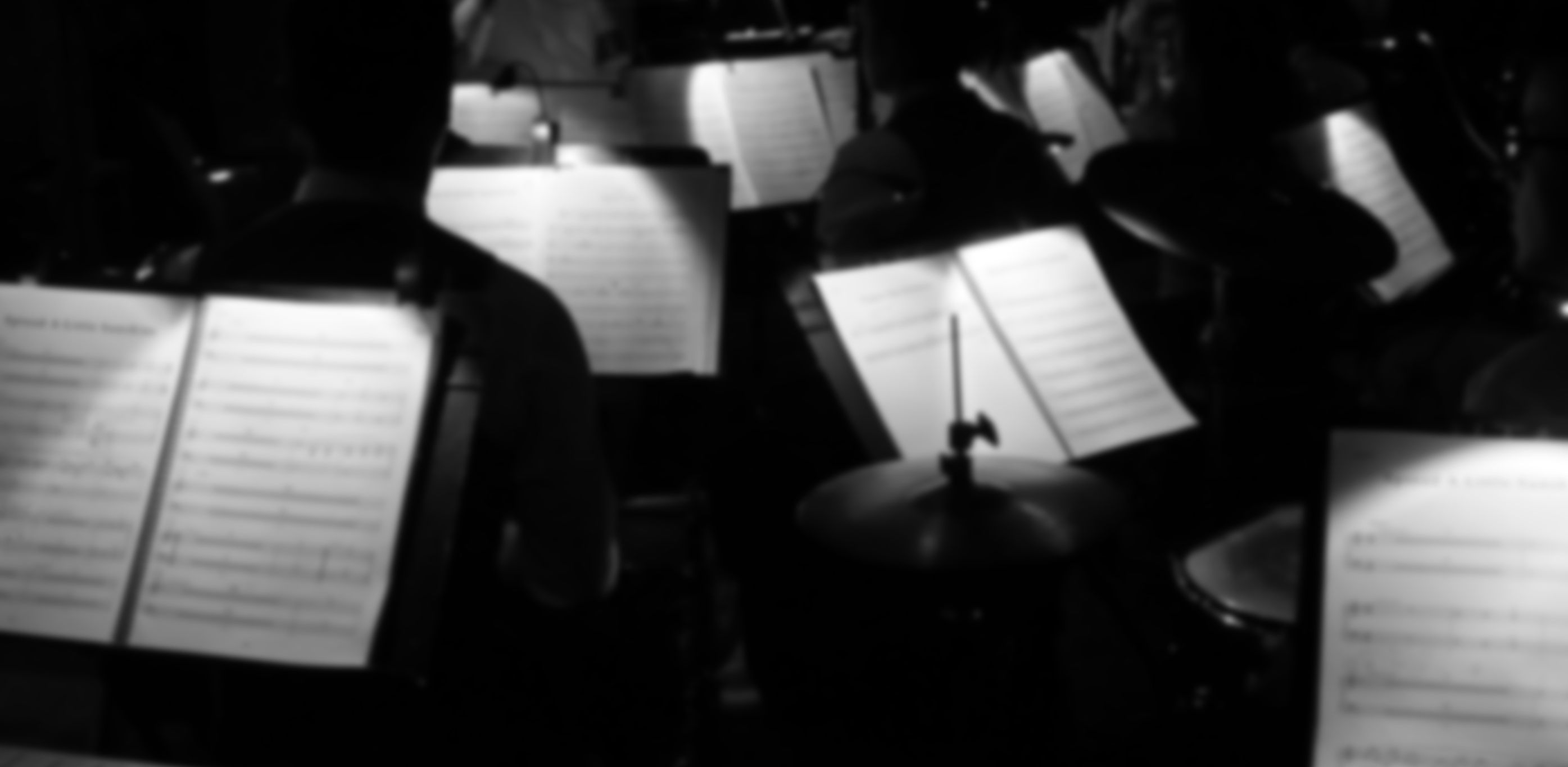 Orchestra pit showing music in black and white